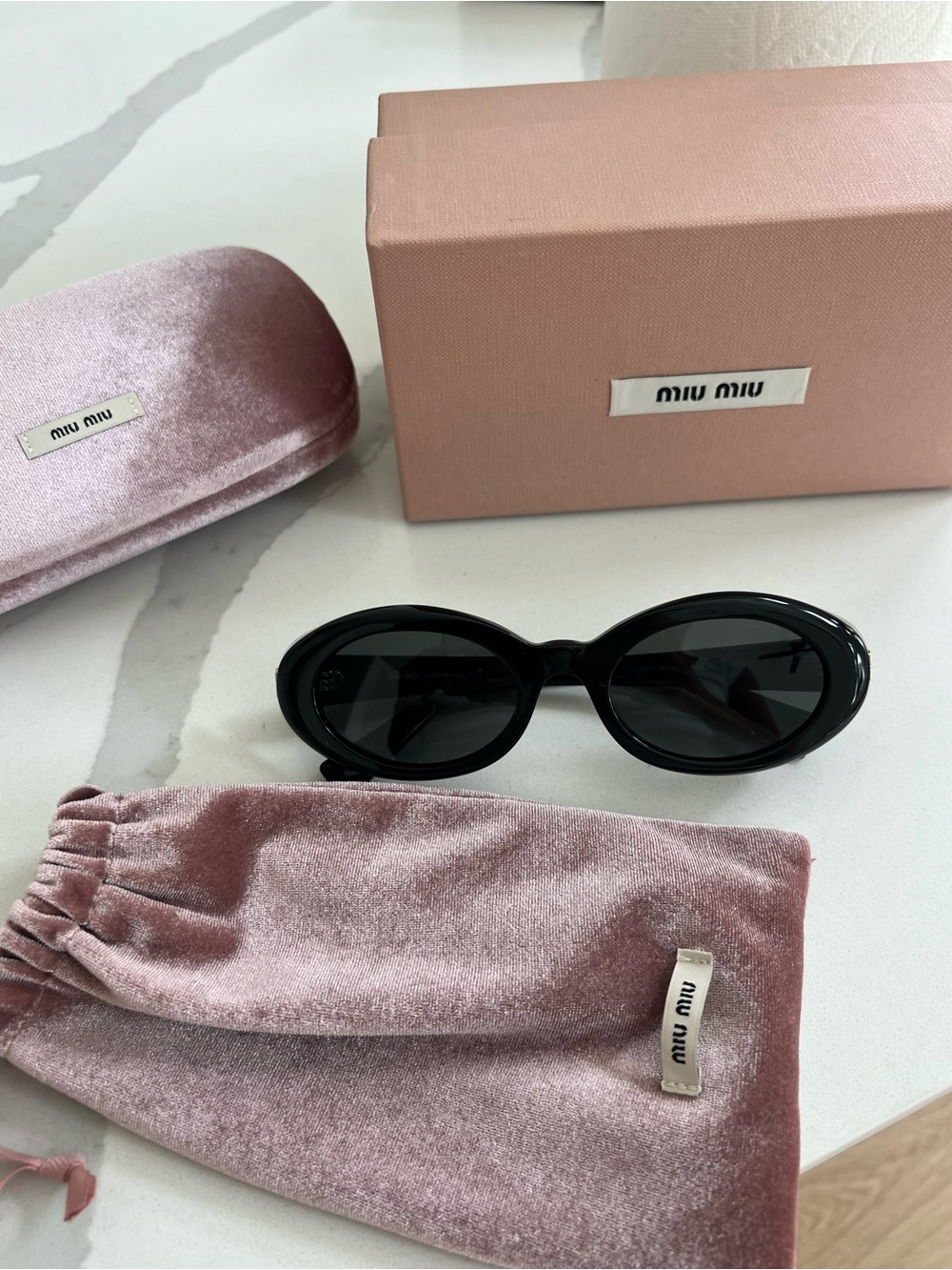 Miu Miu Black Oval Sunglasses with Gold Logo